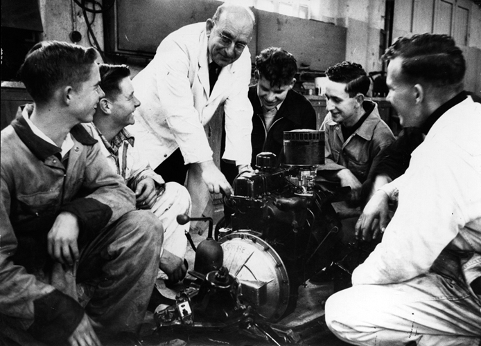 1957 &mdash; Staff and students of Seddon Memorial Technical College examine the features of a new internal combustion engine, presented to them by the Auckland Garage Proprietors&rsquo; Association.