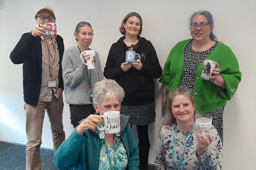 Kākāriki with their resuable mugs for Plastic Free July